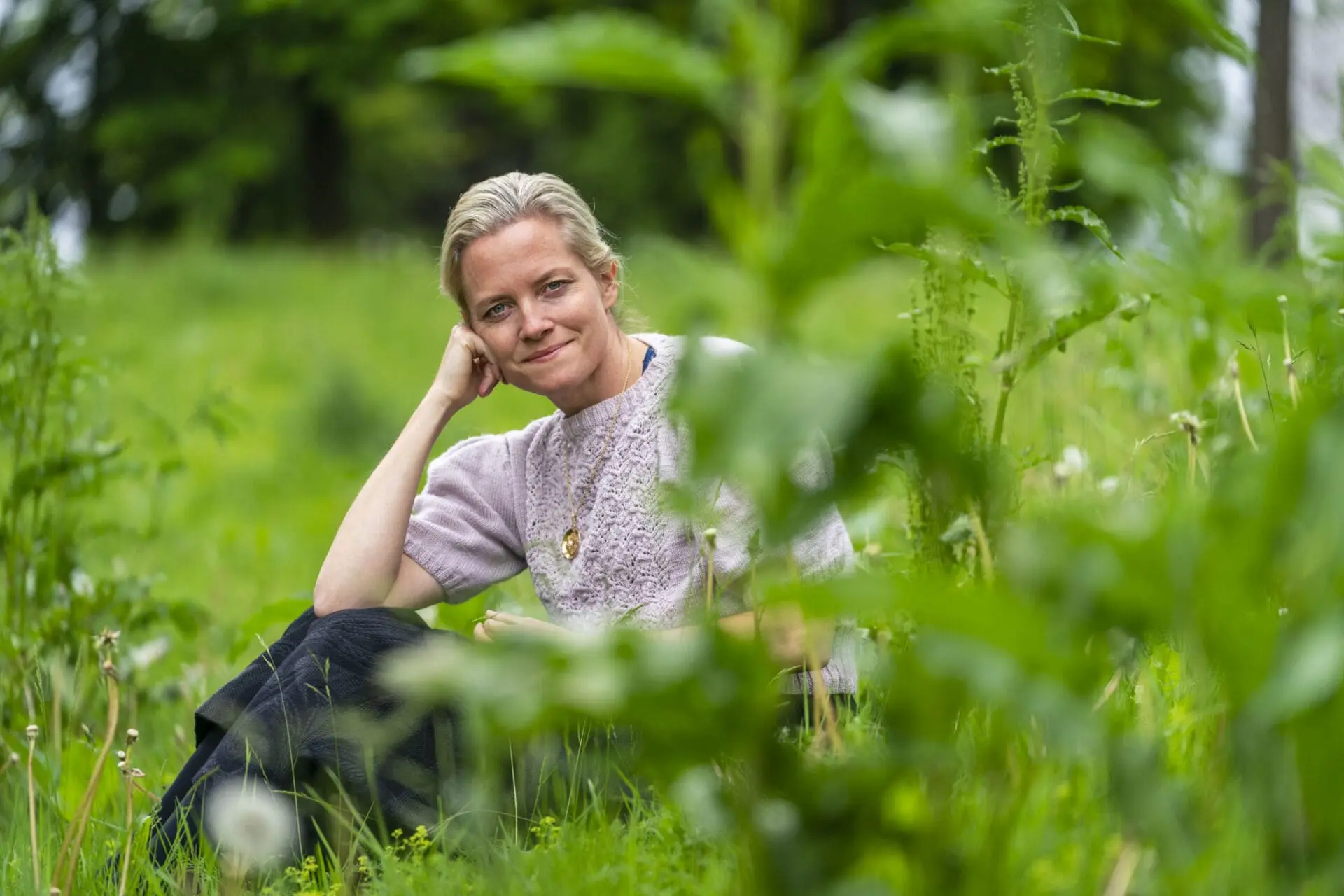 Nina Ellen Ødegård som sitter i gresset
