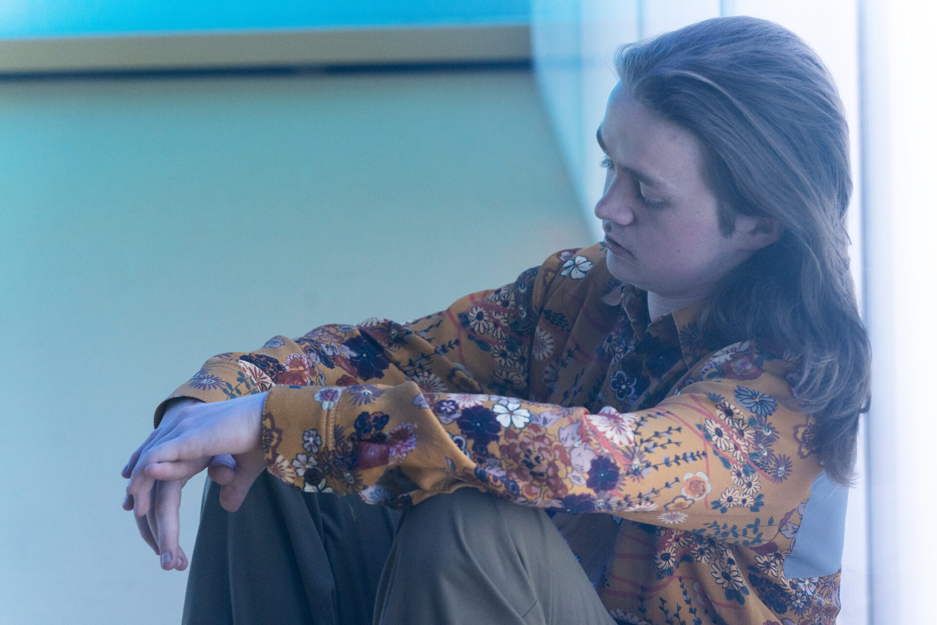 Gutt som sitter og ser ettertenksom ut.