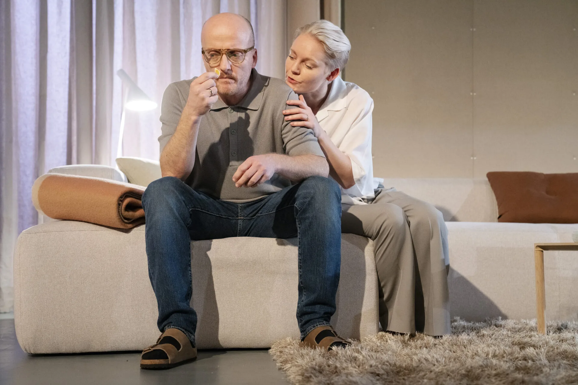 Kvinne og mann som sitter på en sofa.