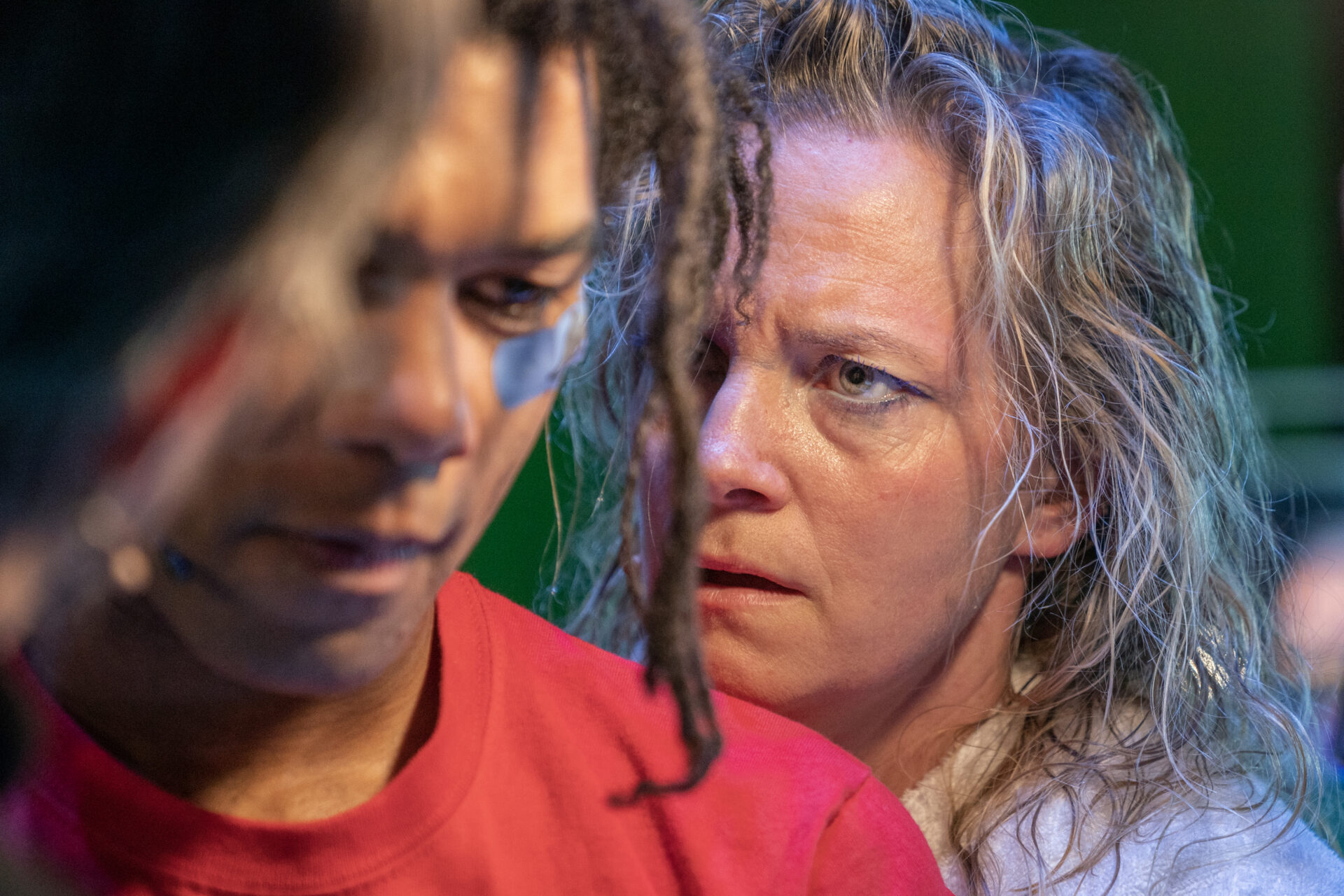 En kvinne som titter alvorlig på en mann, mens han titter ned