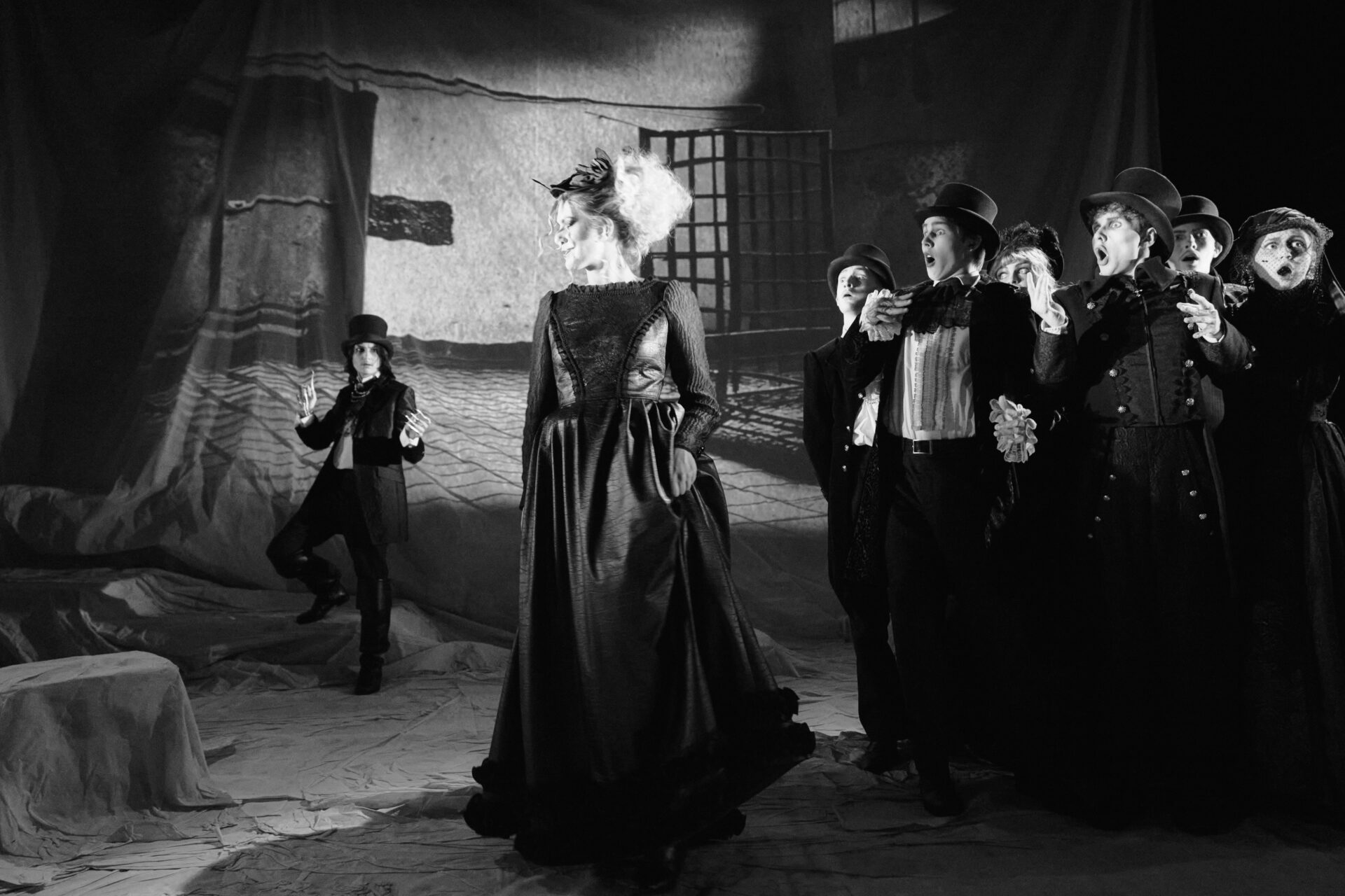 EN gruppe mennesker er forfredet over å se på en kvinne som er kommet ut av en cellle på et psykriatisk asyl