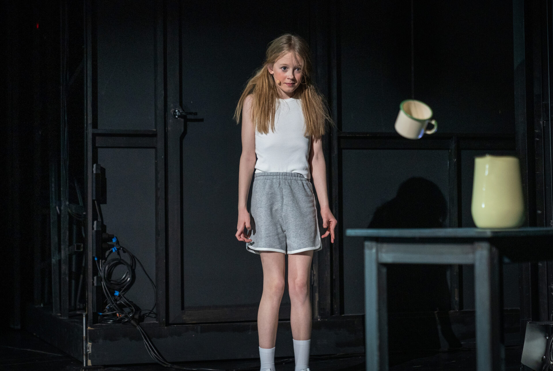 En liten jente bruker magi og flytter en kopp i lufta med tankens kraft